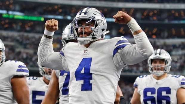 Dallas Cowboys quarterback Dak Prescott (4) celebrates scoring a touchdown in the third quarter against the Atlanta Falcons at AT&T Stadium.